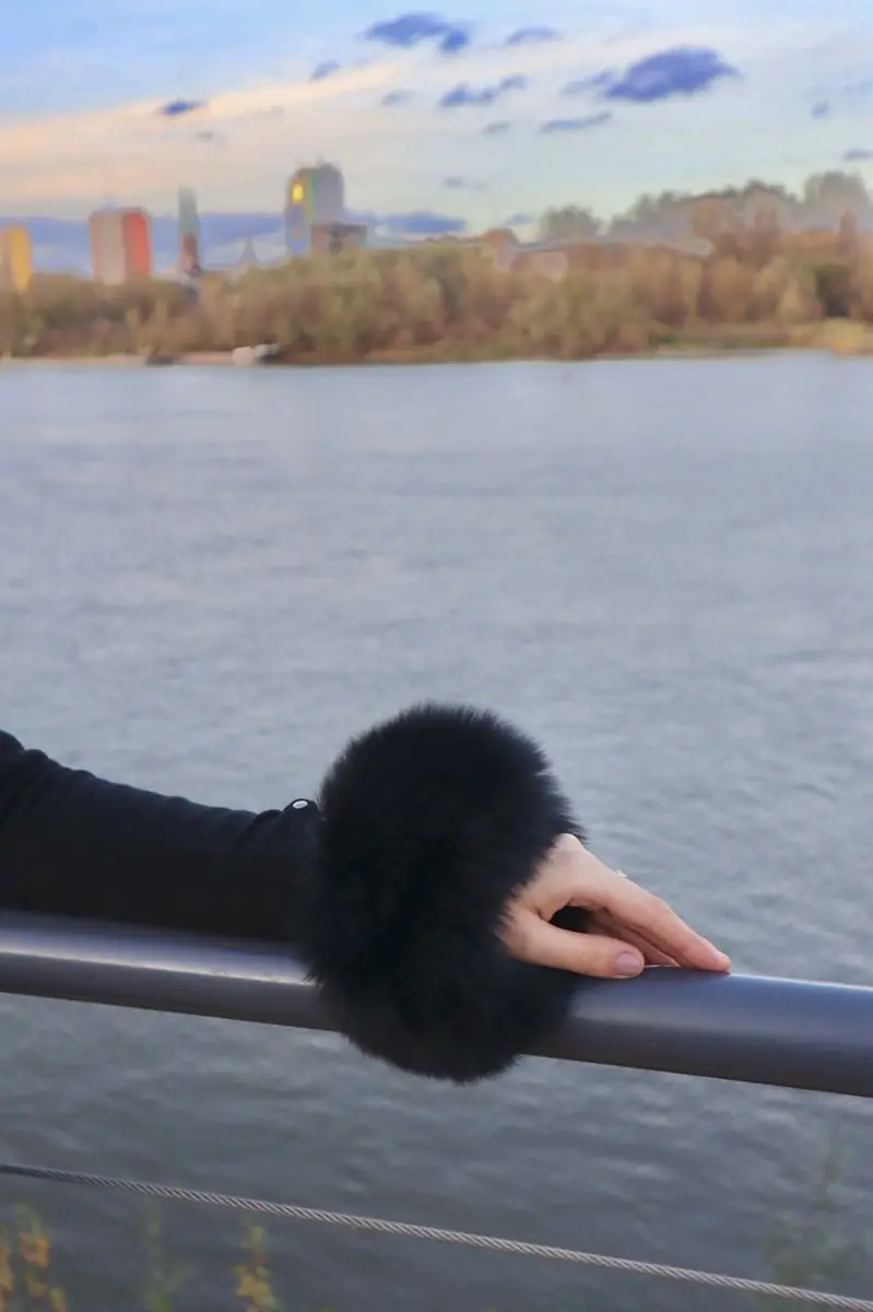 Black real fur cuff resting on a railing