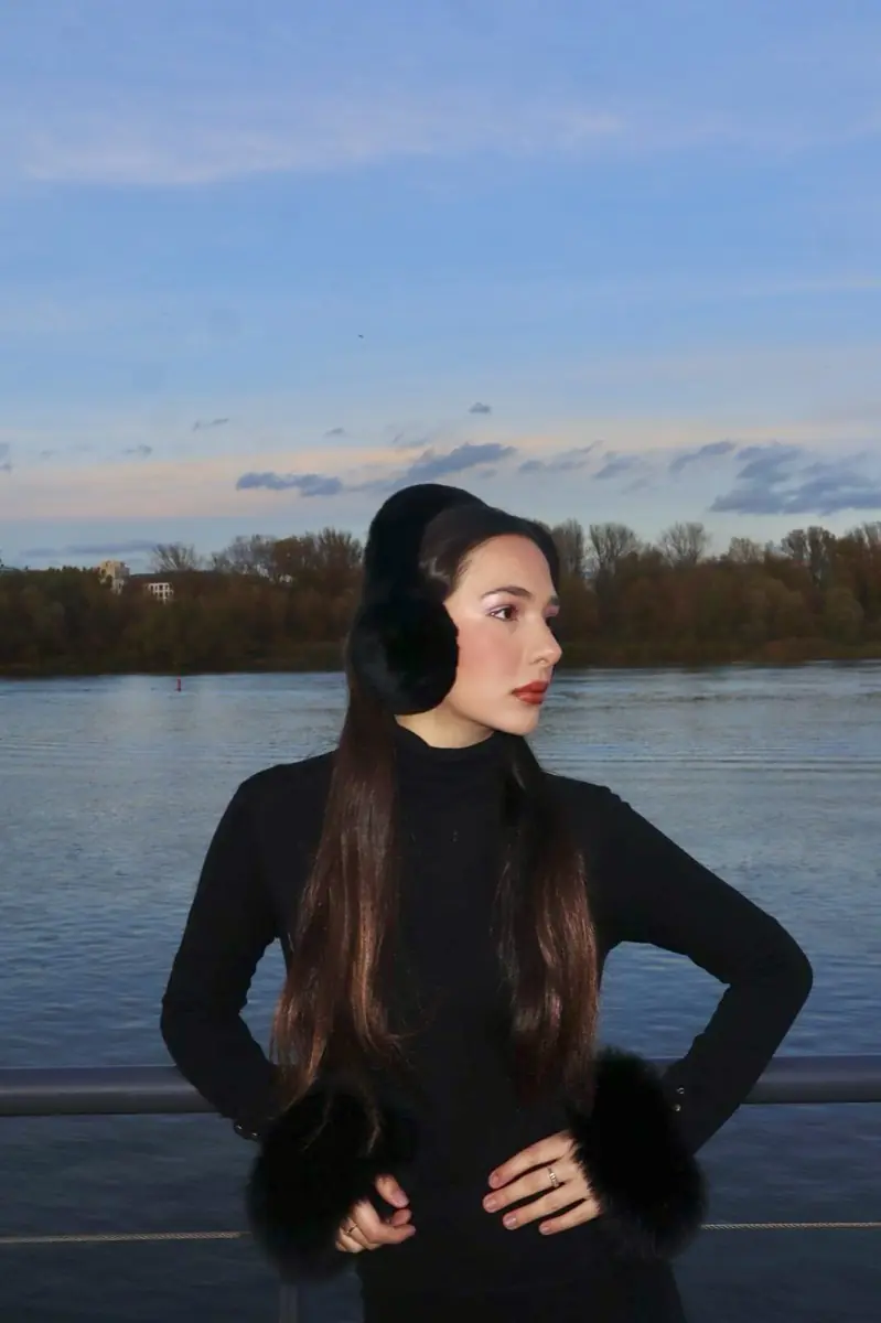 Model wearing black real fur earmuffs
